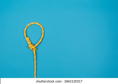 Bowline Loop Knot With Yellow Climbing Rope On Blue Background