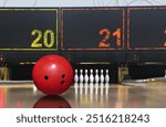 Bowling ball rolling on lane with tenpin in background