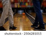 Bowling ball and skittles on a bowling alley in motion