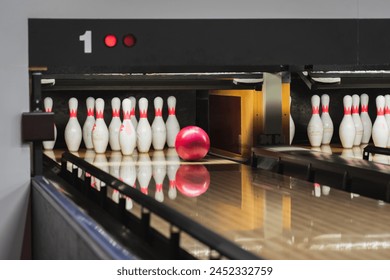 Bowling game, the ball rolls into the pins. 