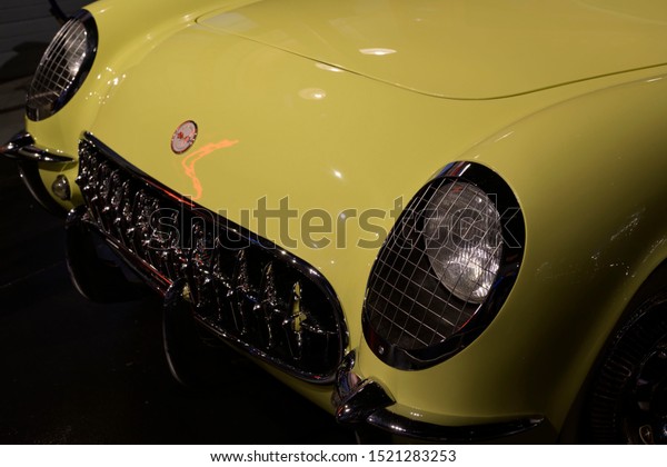 Bowling Green Kentucky, USA-April 19 2019. A\
beautiful yellow vintage Corvette car from the front with classic\
design front light at International Corvette museum Bowling Green\
Kentucky.