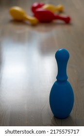 Bowling Pins Knocked Over On The Floor And One Still Standing. Win And Defeat Concept.