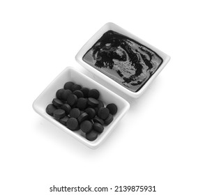 Bowls With Activated Carbon Mask And Pills On White Background