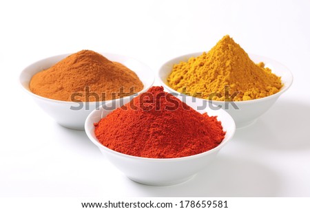 bowls with colorful spices piles