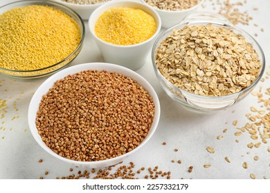 Bowls of different cereals on light background, closeup - Shutterstock ID 2257332179