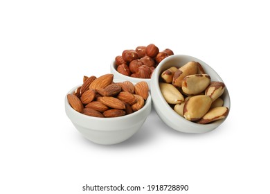 Bowls with different nuts isolated on white background