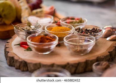 Bowls with different spices. Bay leaves and chili peppers. Traditions and tastes vary. Seasonings for meat dishes. - Shutterstock ID 465882452