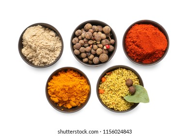 Bowls with different spices on white background - Shutterstock ID 1156024843