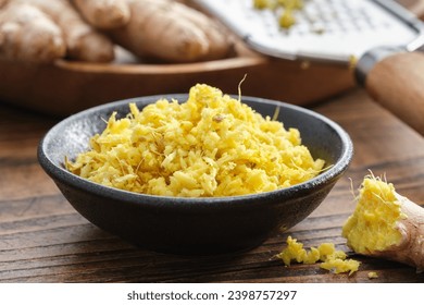 Bowls of grated fresh ginger roots. Whole ginger roots and grater on background. Healthy food. Ingredients for cooking and Ayurveda. - Powered by Shutterstock