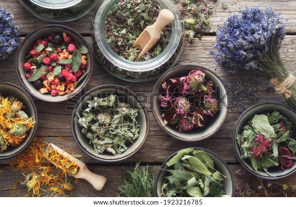 Bowls and jars of dry\
medicinal herbs. Healing herbs assortment, top view. Alternative\
medicine.