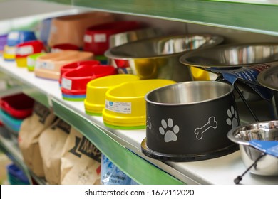 Bowls on shelves in pet shop, close up