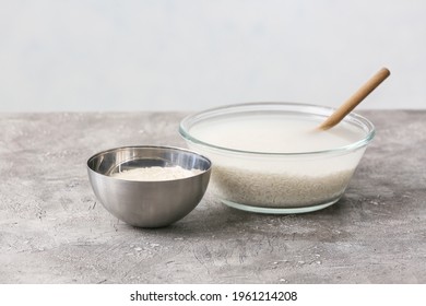 Bowls With Rice And Water On Table