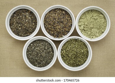 bowls of seaweed diet supplements (bladderwrack, sea lettuce, kelp powder, wakame and Irish moss) - top view