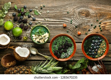 Bowls With Spirulina Smoothie On Wooden Table