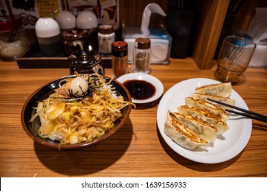 Bowls With Tasty Japanese Gyoza And Rice With Pork, Fried Onion And Egg. Tokyo, Japan.