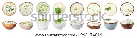 Bowls of tasty sour cream with herbs on white background
