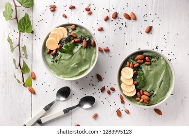 Bowls With Tasty Spirulina Smoothie On White Table