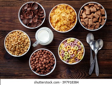Bowls of various cereals and milk from top view - Shutterstock ID 397918384
