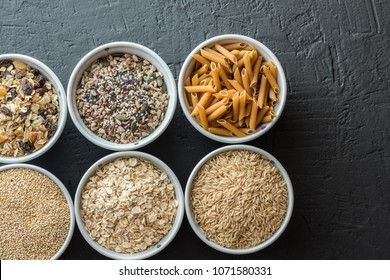 Bowls With Whole Grain Carbohydrates, Oats, Brown Rice, Seeds, Quinoa And Whole Grain Pasta. Healthy Food Concept