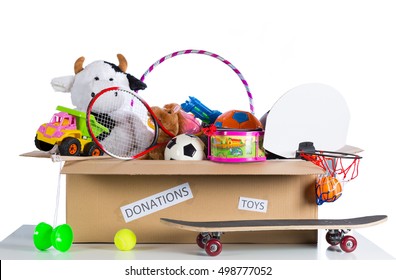Box of assorted toys to donate with white background
