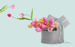 Box With Beautiful Tulip Flowers And Gifts On Light Background