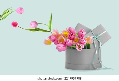 Box with beautiful tulip flowers and gifts on light background - Powered by Shutterstock