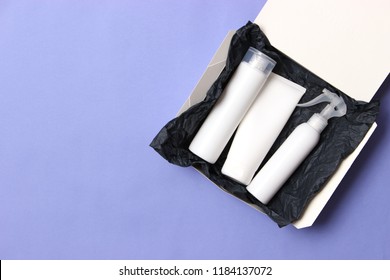 Box Of Beauty With Cosmetics For Hair On A Colored Background Top View. Flatlay