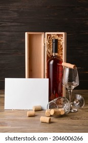 Box With Bottle Of Wine, Glasses And Gift Card On Wooden Background