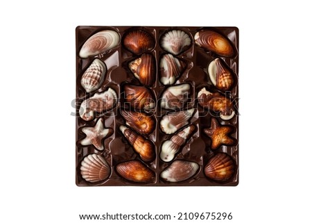 Box of chocolates seashells isolated on white background.