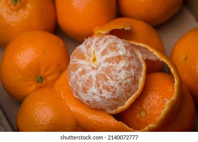 box of clenentines with peeled clementine