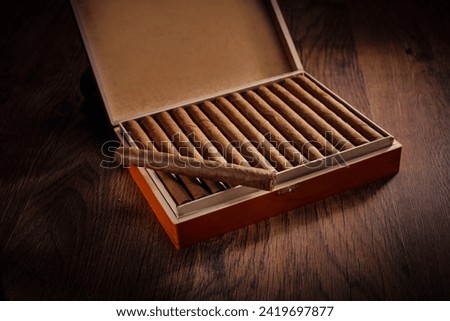 Box of cuban cigars on a dark brown wooden floor