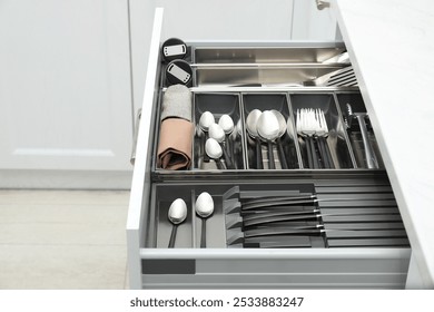 Box with cutlery in drawer indoors. Kitchen utensils storage - Powered by Shutterstock