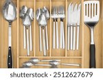 Box with cutlery in drawer, top view. Kitchen utensils storage