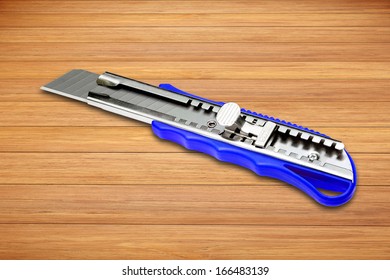 A Box Cutter On Wooden