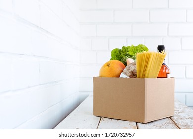 Box Delivery Groceries On A White Wooden Table, Order Food Online During Coronavirus. Food Delivery Or Donation Concept. Copy Space