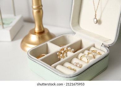 Box and different stylish jewelry white table  closeup