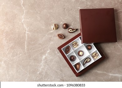 Box With Different Tasty Chocolate Candies On Table, Top View