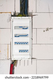 Box With Electric Switch Fuses Or Circuit Breakers Installed On Bare Wall In New House Construction Site