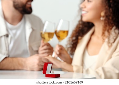 Box With Engagement Ring On Table Of Young Couple. Marriage Proposal Concept