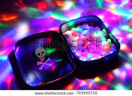 A box filled with ecstasy under disco lights./The dealer sells drugs to discos.