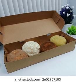 A box of four assorted delicious donuts 1