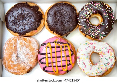 Box full of donuts, half a dozen donuts.