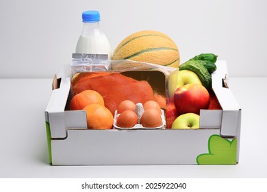 A box full of food in concept donation box isolated on white. Fresh vegetables in cardboard box. Box full of colorful fresh vegetables and fruits on a white background, ideal for a balanced diet.