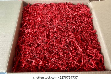 Box full of red package filling paper only, shredded zig zag 