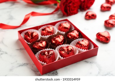 Box With Heart Shaped Chocolate Candies On White Marble Table