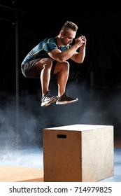 Box jump exercise young man doing functional workout at the gym
