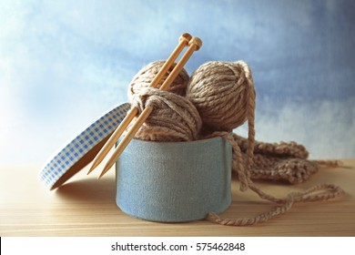 Box With Knitting Yarn And Needles On Table