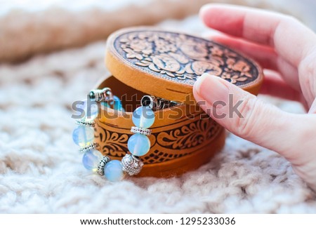 Box with a lid made of birch bark with a bracelet made of moonstone. Decoration
