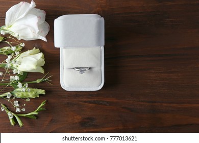 Box With Luxury Engagement Ring On Wooden Background, Top View