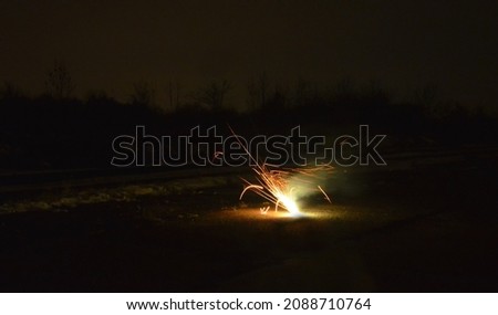 box with night explosion full of explosive pyrotechnics. white orange fireball in the shape of a white bush with lots of hot shards. Cluster bombs falling on the street bullets glowing shrapnel flames